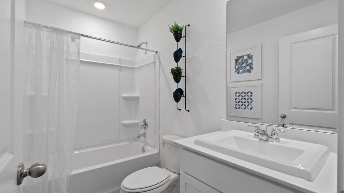 Secondary bathroom with tub/shower combo with quartz counter tops in Magnolia TX