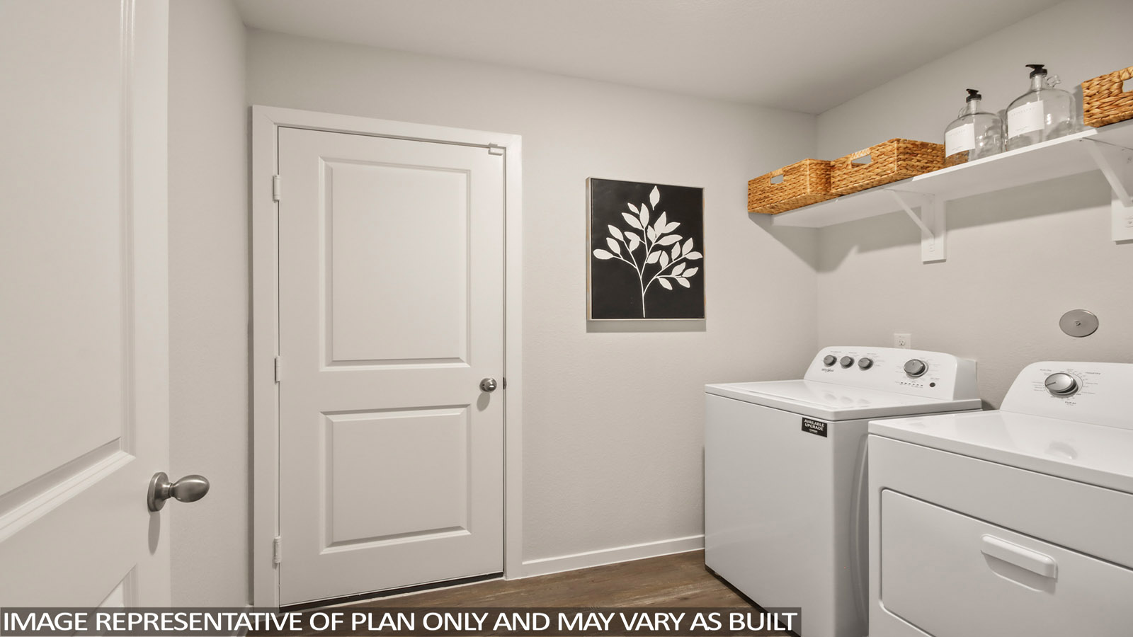 Utility room with storage located off the entry hallway and garage door