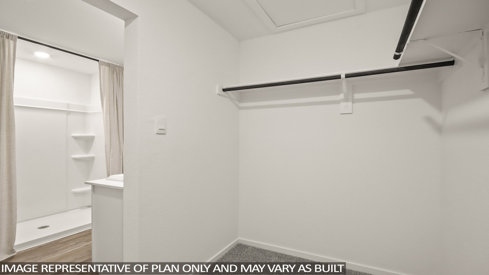 Primary bedroom walk-in closet with carpet flooring in Mill Creek community in Magnolia TX