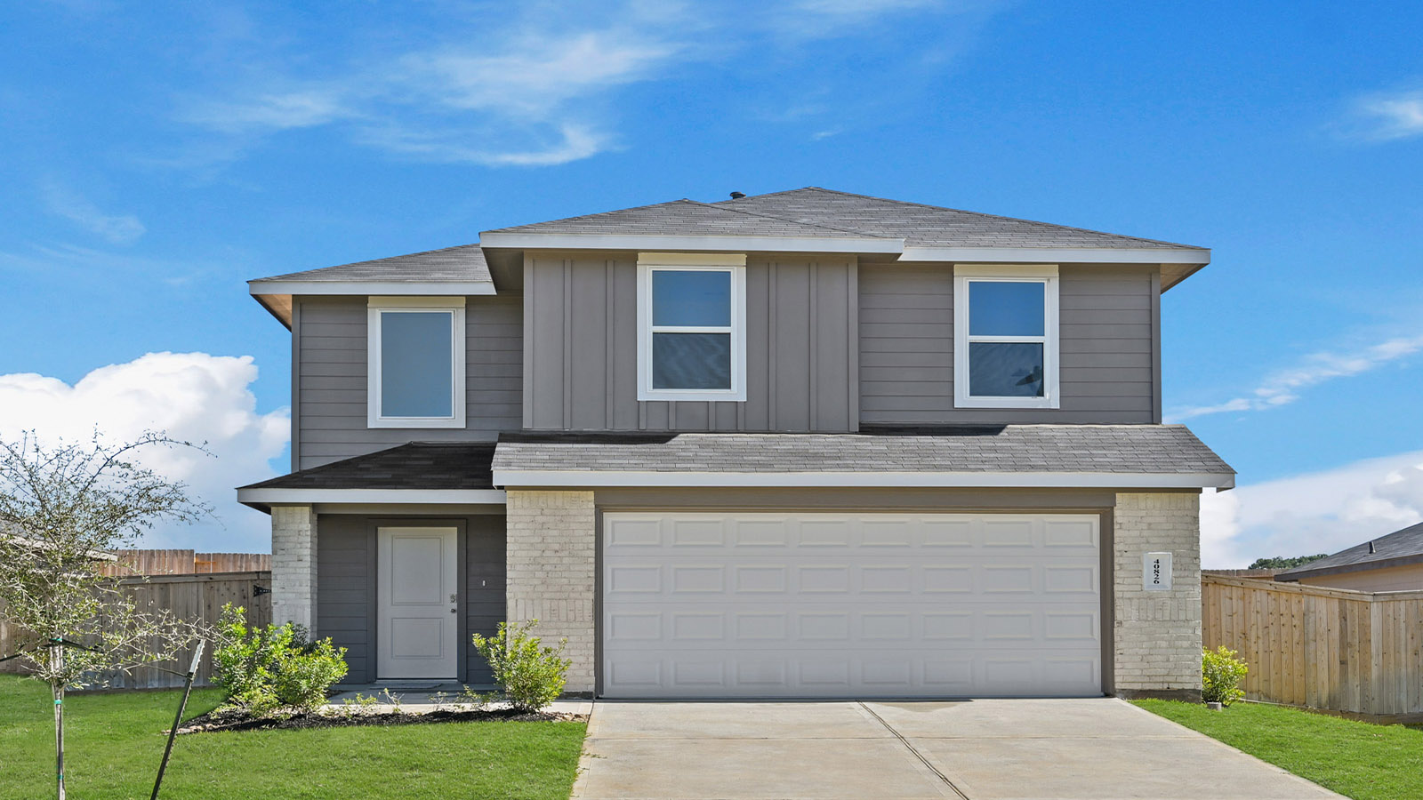 two story home with siding and stone