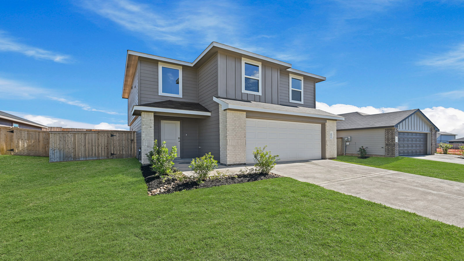 two story home with siding and stone