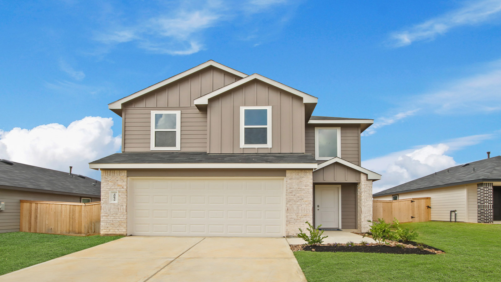 two story home with siding and stone