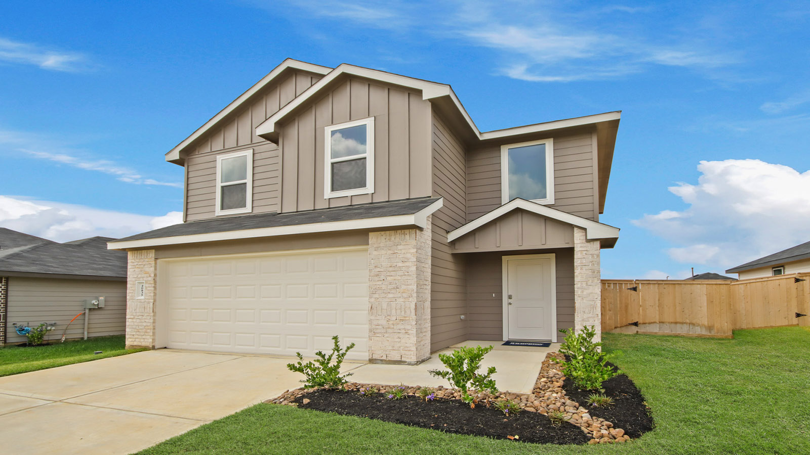 two story home with siding and stone