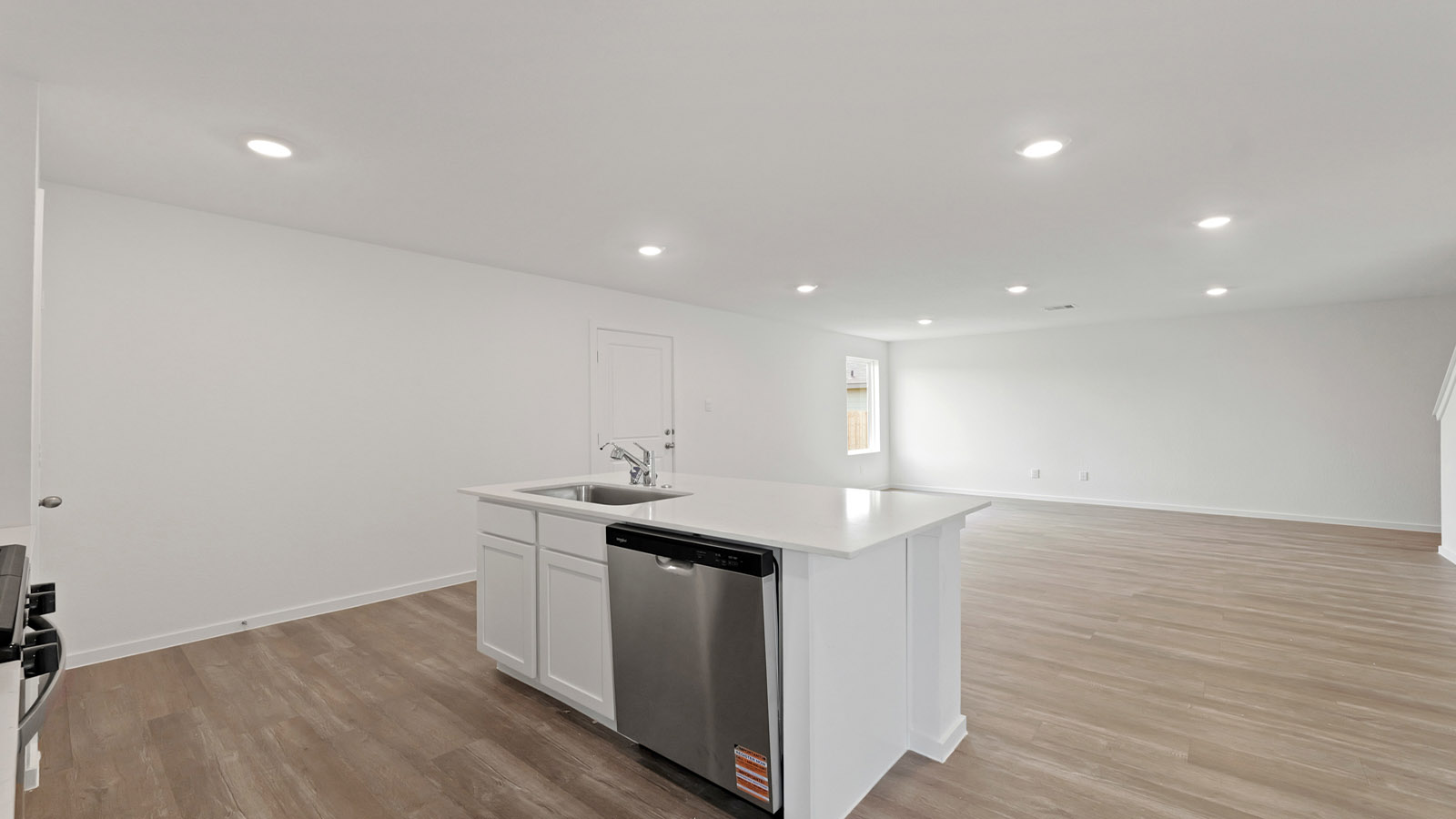 bright and open kitchen with island and vinyl floor