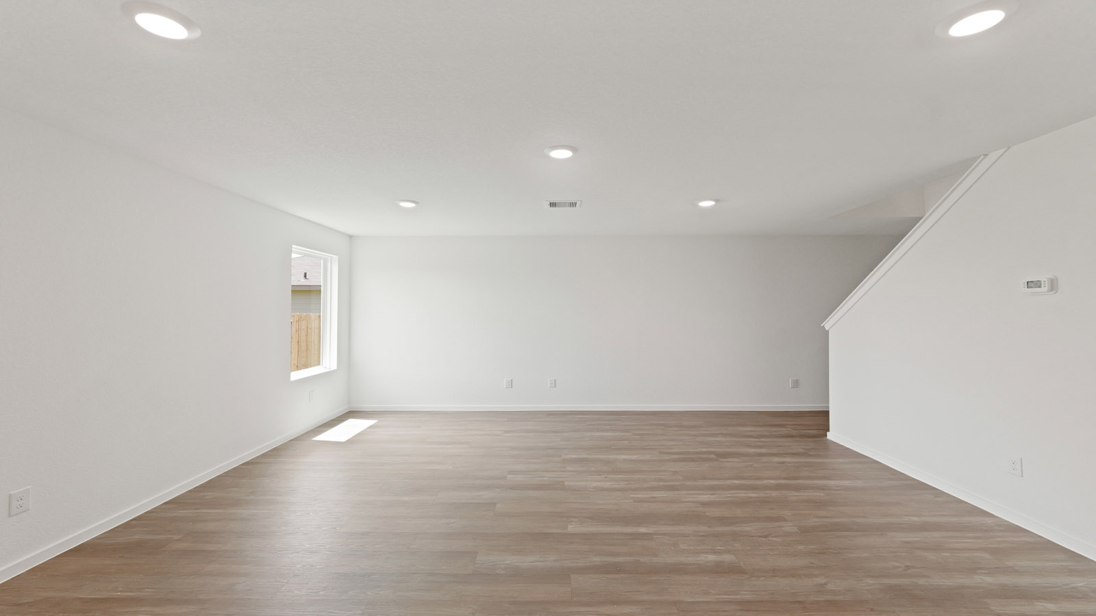 bright and open living room with vinyl floor
