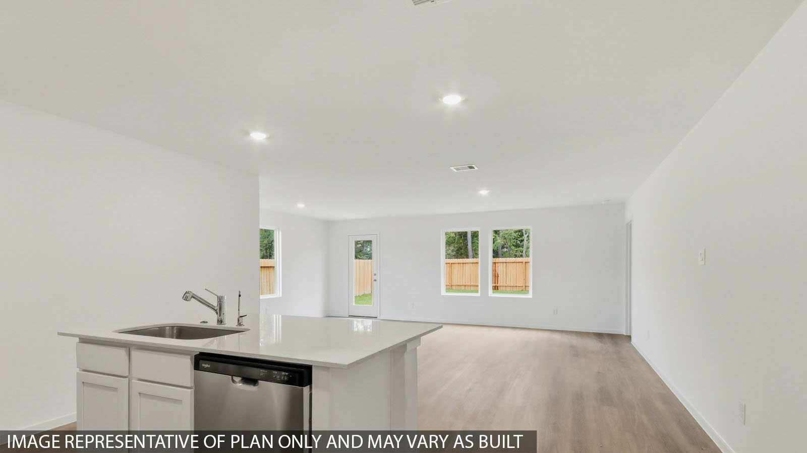 Kitchen with quartz countertops and marden hardware and an island and vinyl floor
