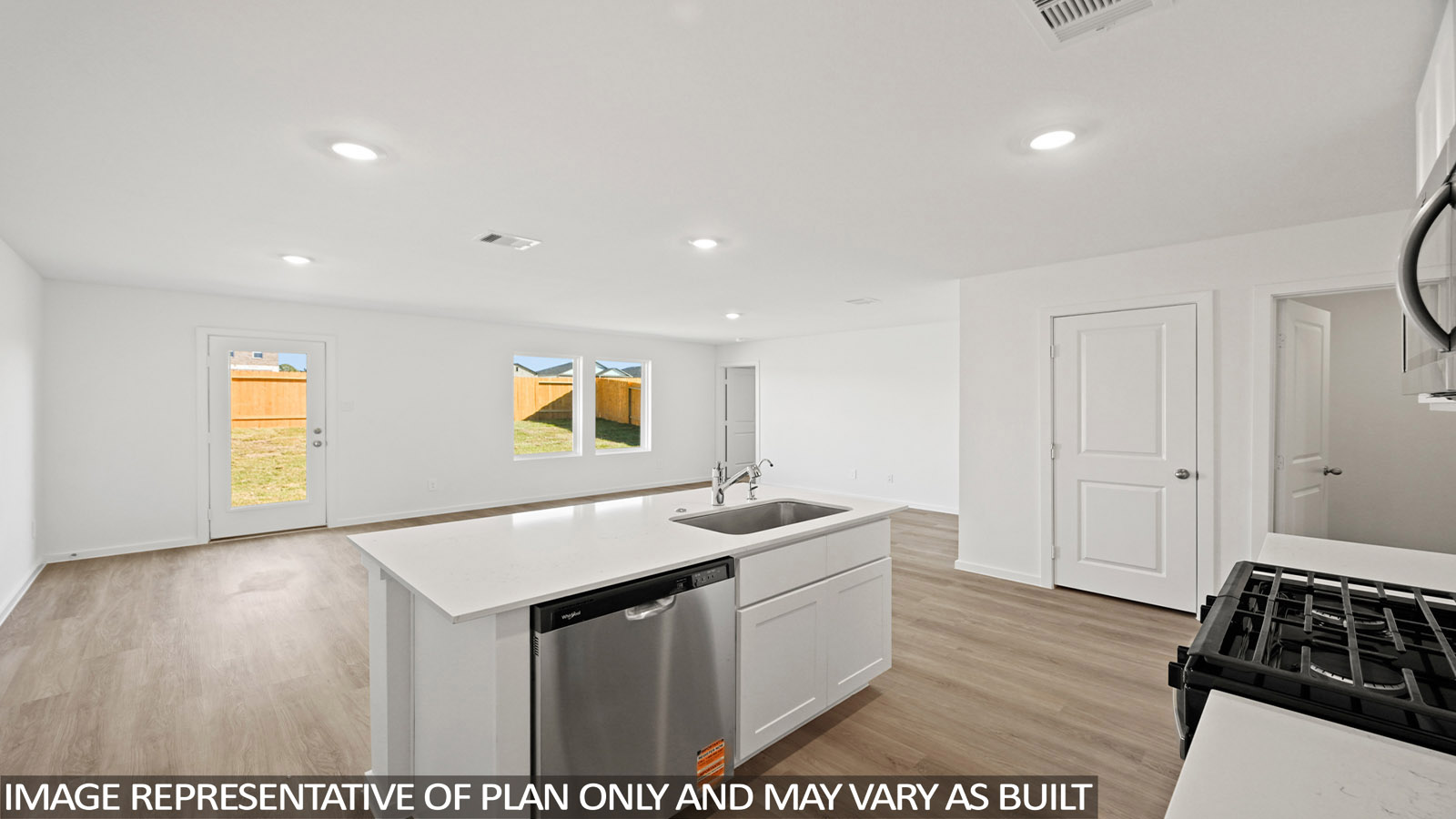 Open concept living, dining, and kitchen area with vinyl flooring and bright windows