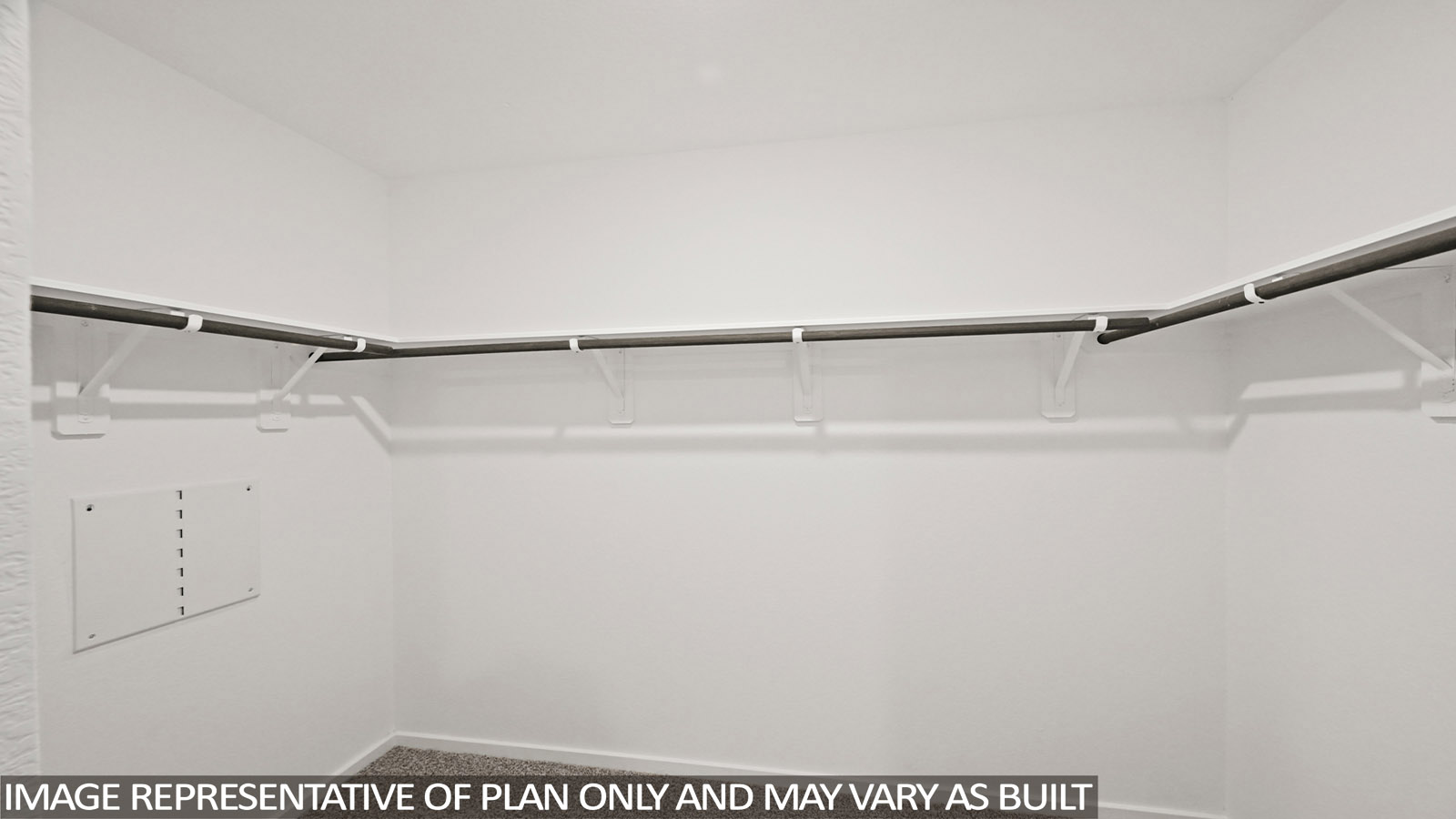 Primary bedroom walk-in closet with carpet flooring in Mill Creek community in Magnolia TX