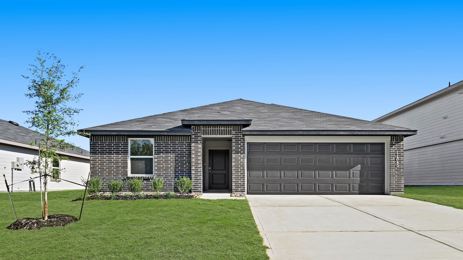 One story home with two car garage with brick and siding in Magnolia TX