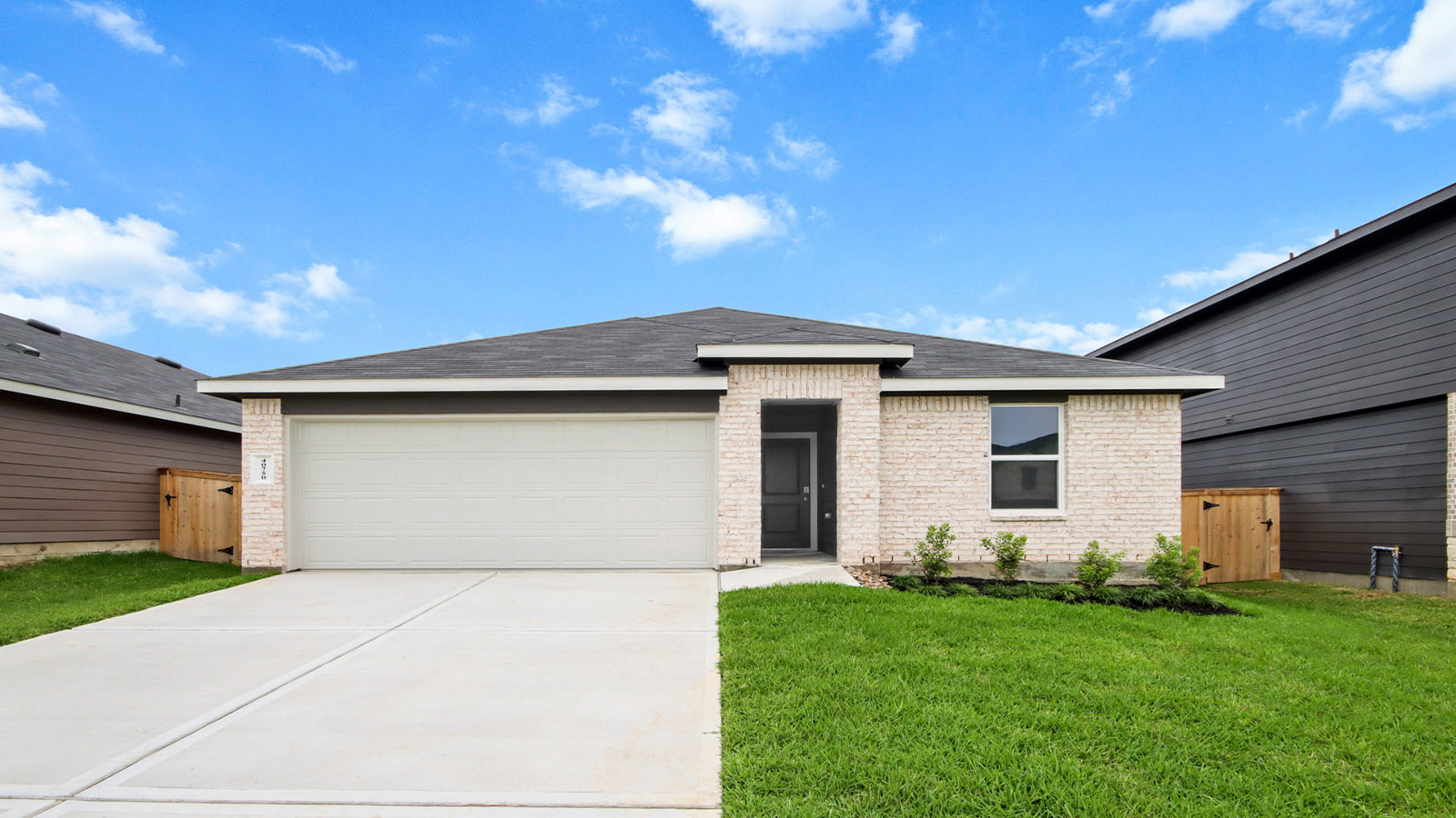 One story home with two car garage with brick and siding in Magnolia TX