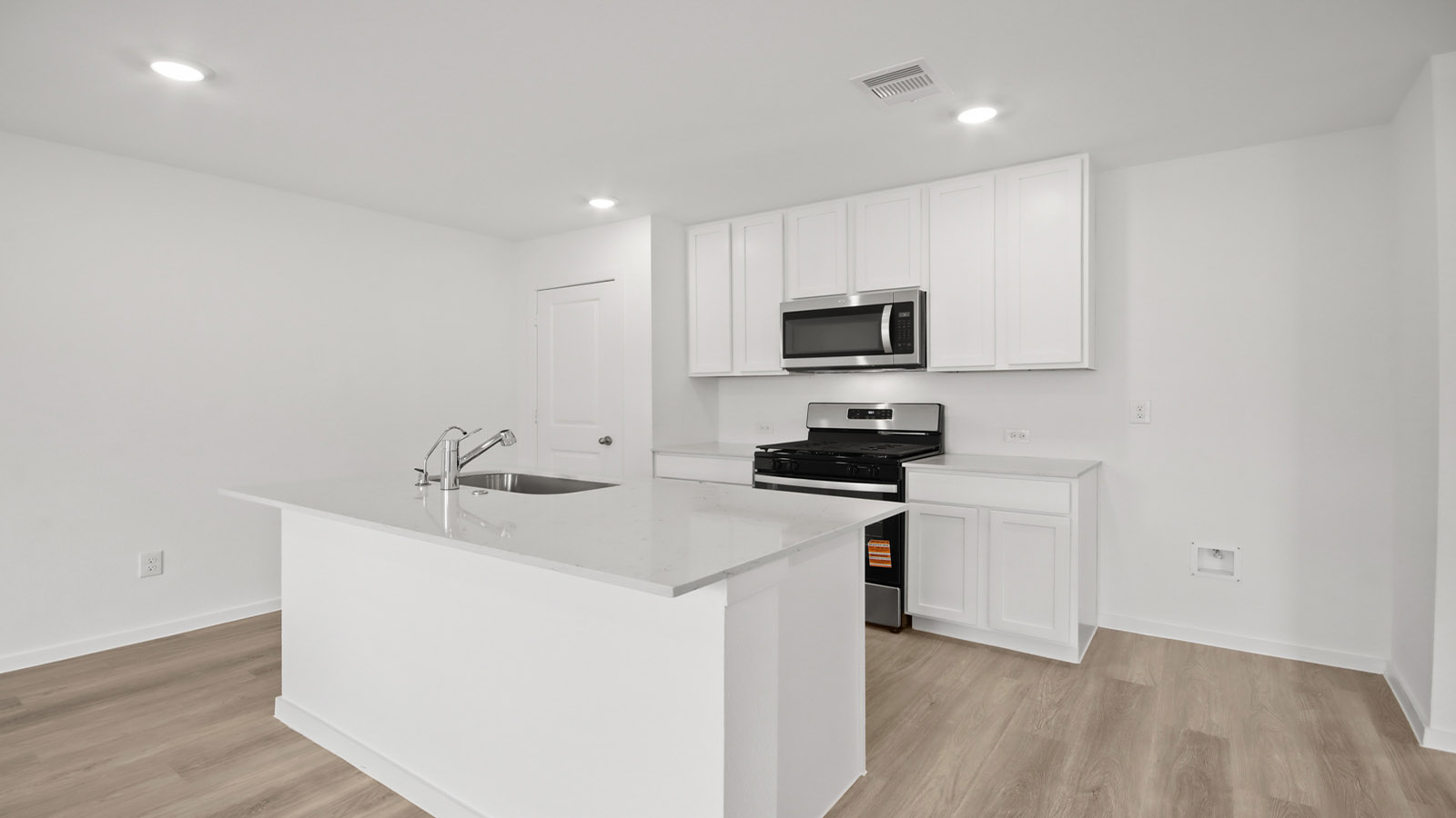 Kitchen with quartz countertops and marden hardware and an island and vinyl floor