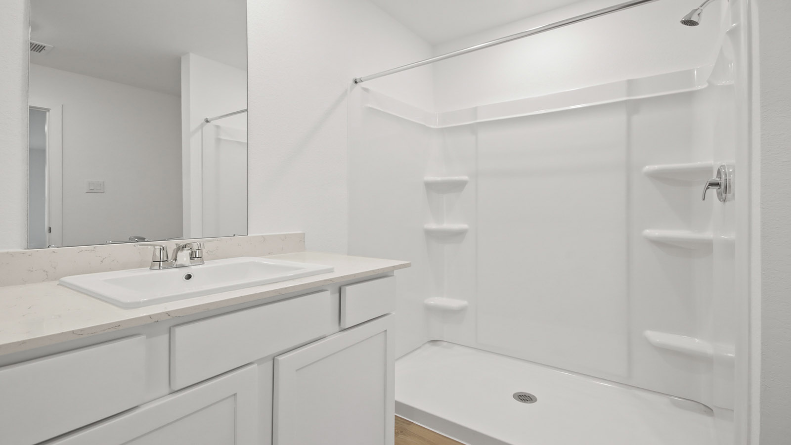 Primary bathroom with stand-alone shower with tiles and semi frameless glass in Magnolia TX