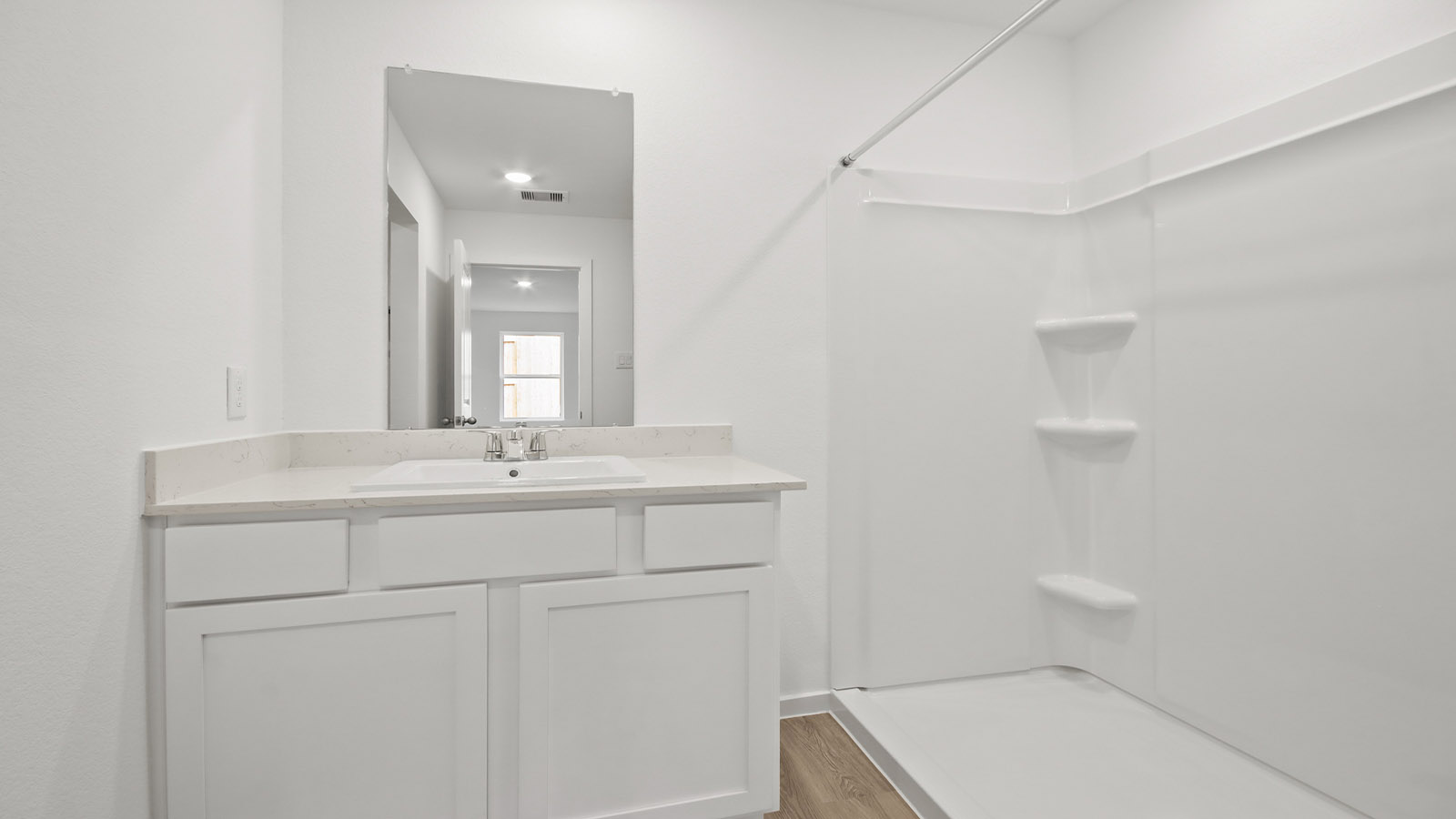 Primary bathroom with stand-alone shower with tiles and semi frameless glass in Magnolia TX