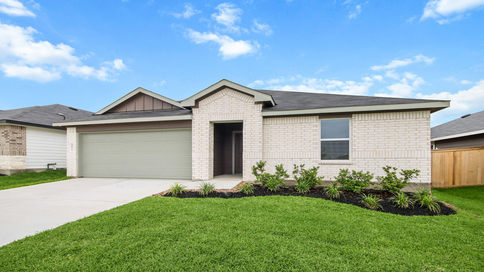 One story home with two car garage with brick and siding in Magnolia TX