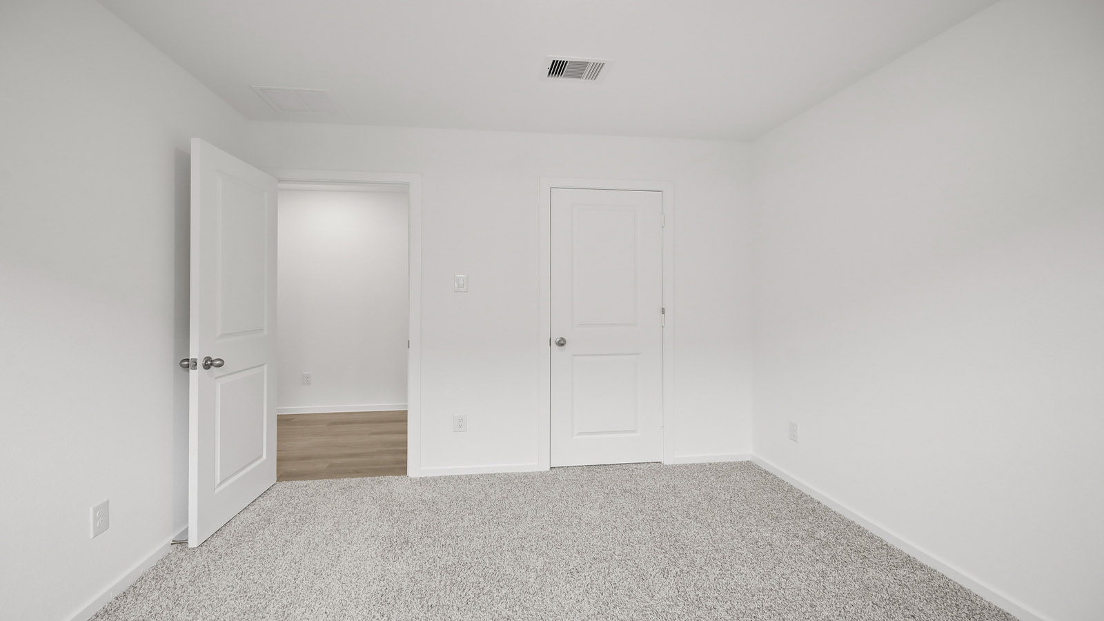 Secondary bedroom with shag carpet flooring and bright window