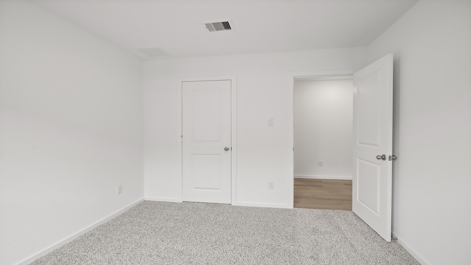 Secondary bedroom with shag carpet flooring and bright window