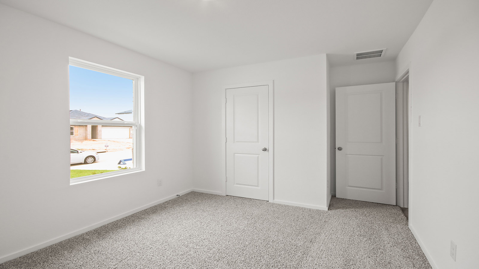 Secondary bedroom with shag carpet flooring and bright window
