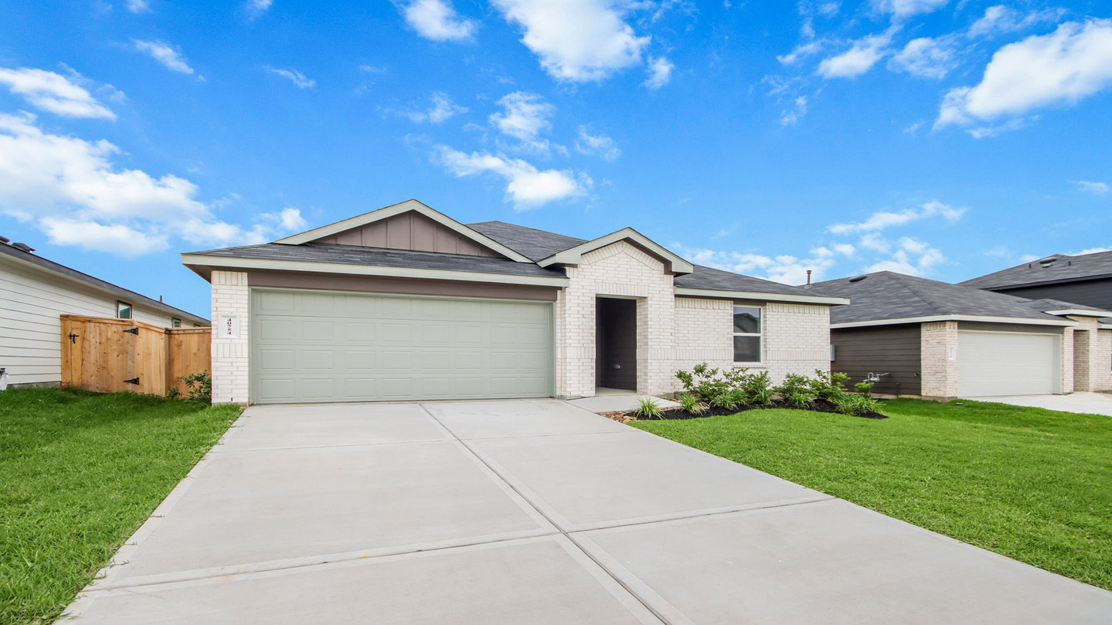 One story home with two car garage with brick and siding in Magnolia TX