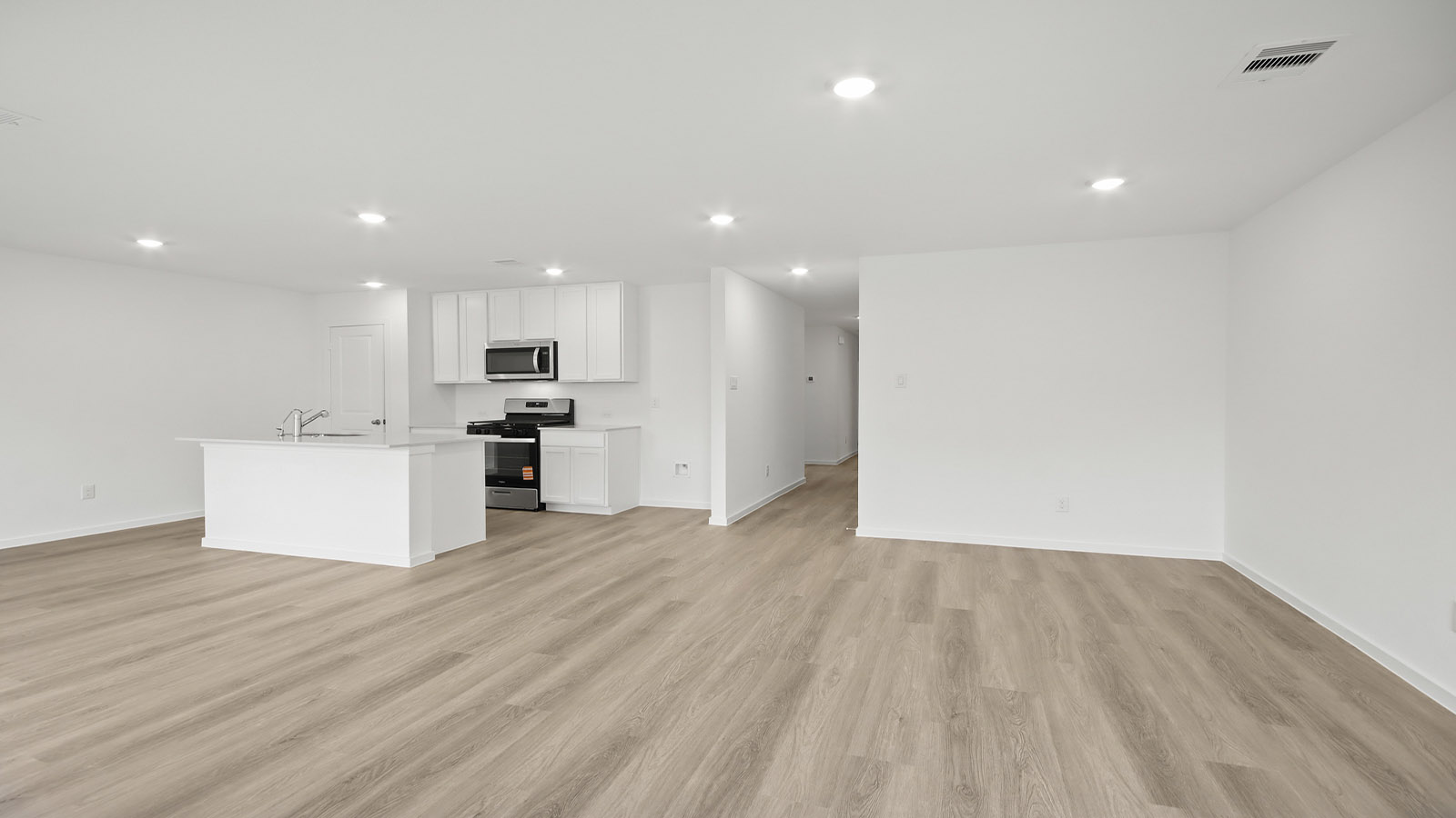 Spacious living area with vinyl flooring and bright windows in Magnolia TX