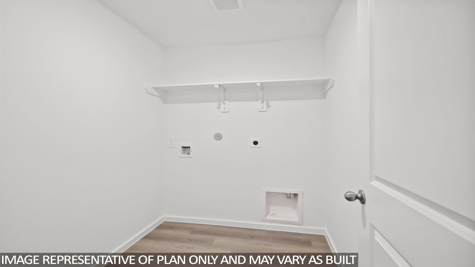 Utility room with storage located off the entry hallway and garage door
