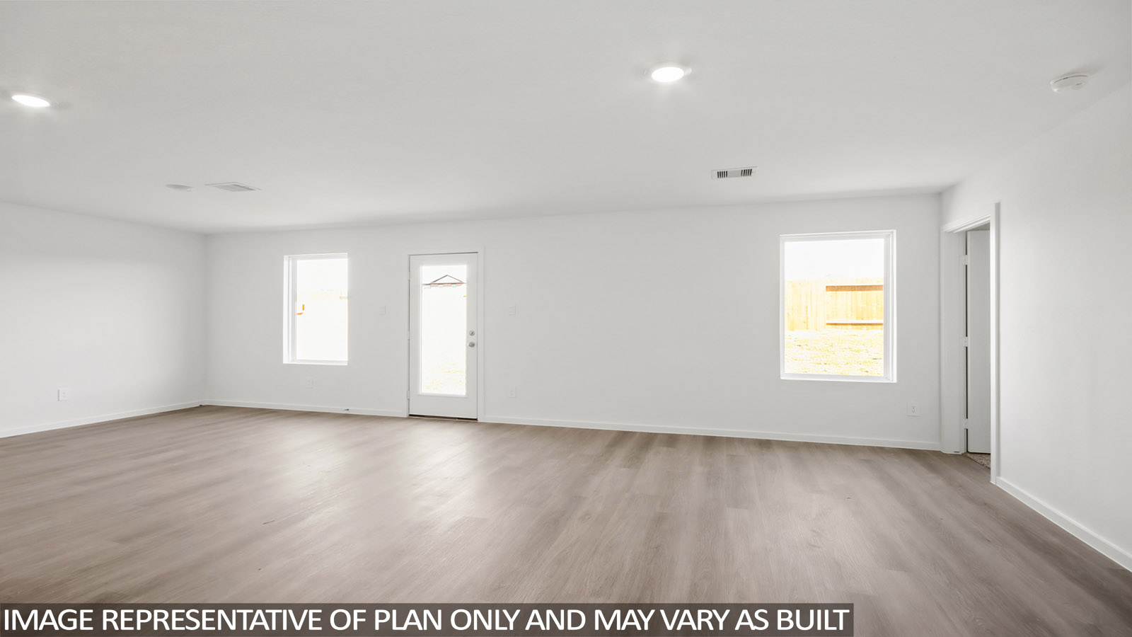 Spacious living area with vinyl flooring and bright windows in Magnolia TX