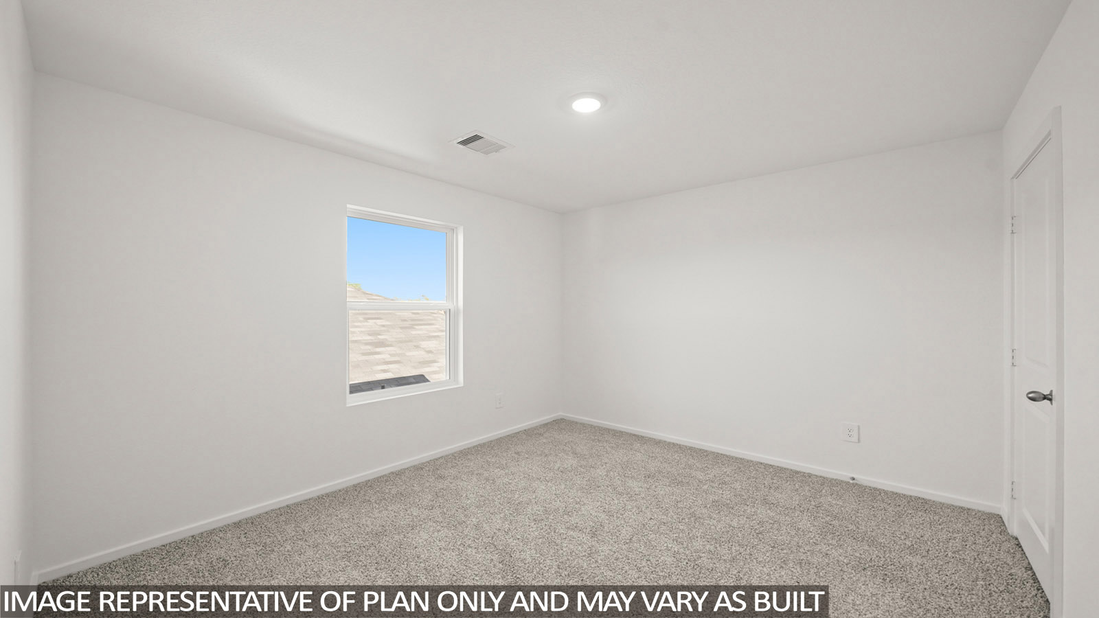 Secondary bedroom with carpet flooring