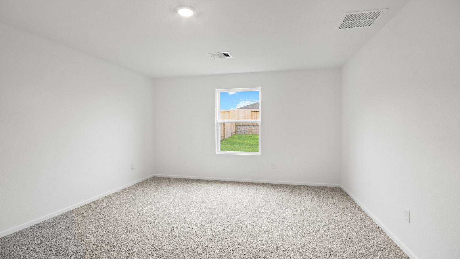 Large Primary bedroom with shag carpet flooring and bright window