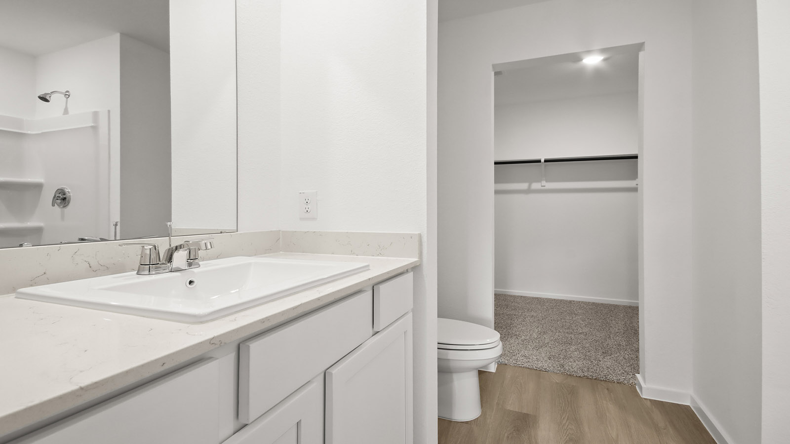 Primary bathroom with double sinks with quartz counter tops in Magnolia TX