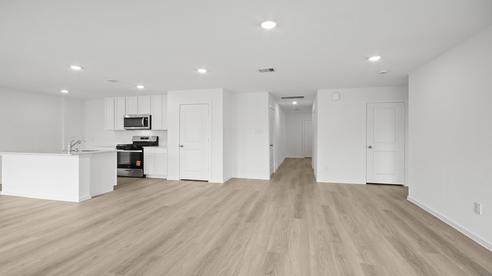 Spacious living area with vinyl flooring and bright windows in Magnolia TX