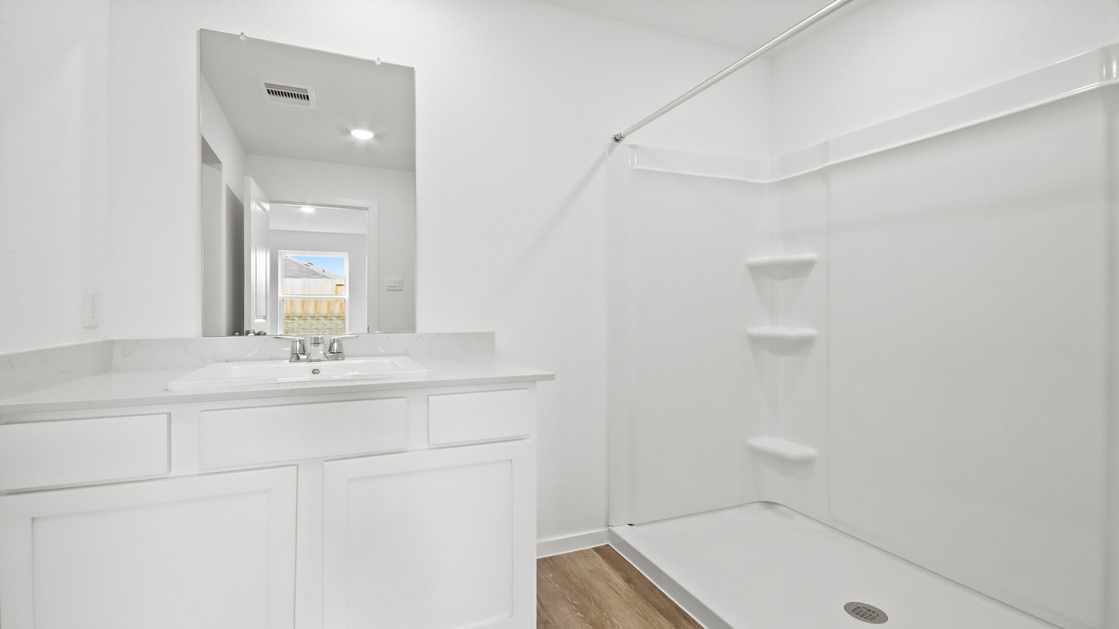 Primary bathroom with stand-alone shower with tiles and semi frameless glass in Magnolia TX