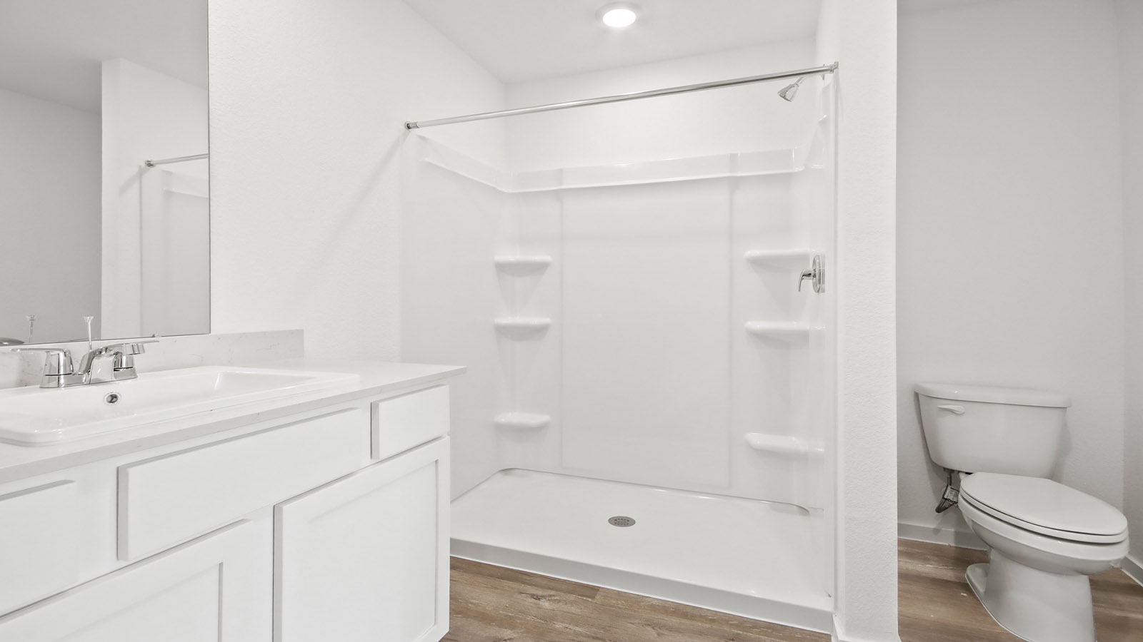 Primary bathroom with stand-alone shower with tiles and semi frameless glass in Magnolia TX