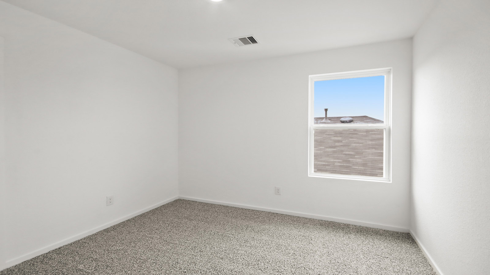 Second level secondary bedroom with carpet flooring and bright window
