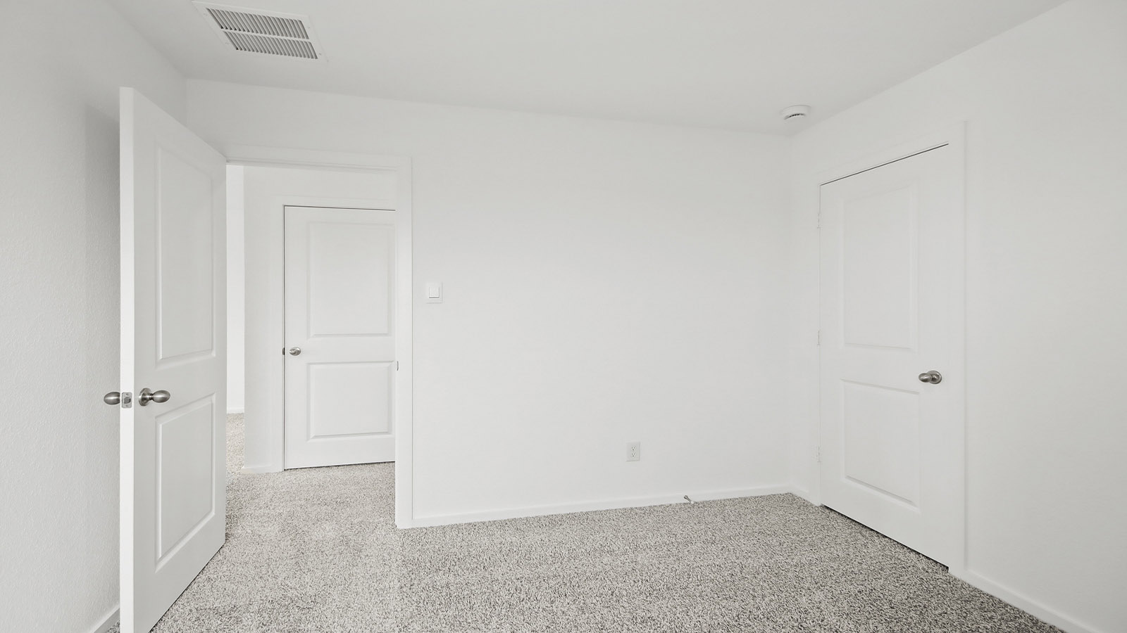 Second level secondary bedroom with carpet flooring and bright window
