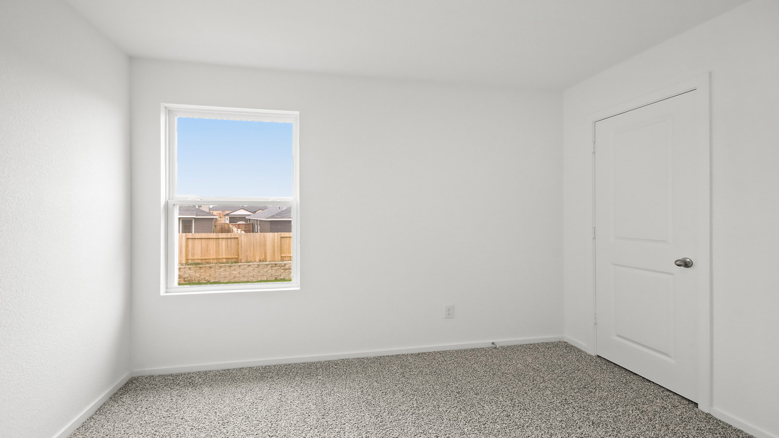 Second level secondary bedroom with carpet flooring and bright window