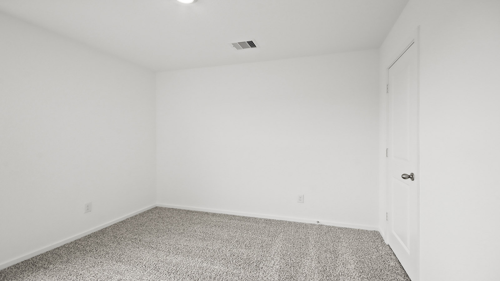 Second level secondary bedroom with carpet flooring and bright window