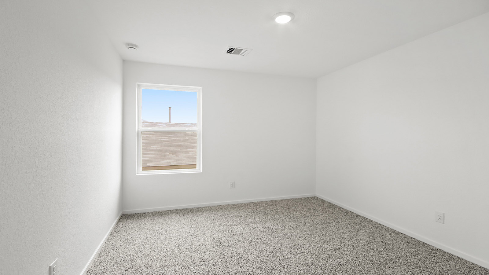 Second level secondary bedroom with carpet flooring and bright window