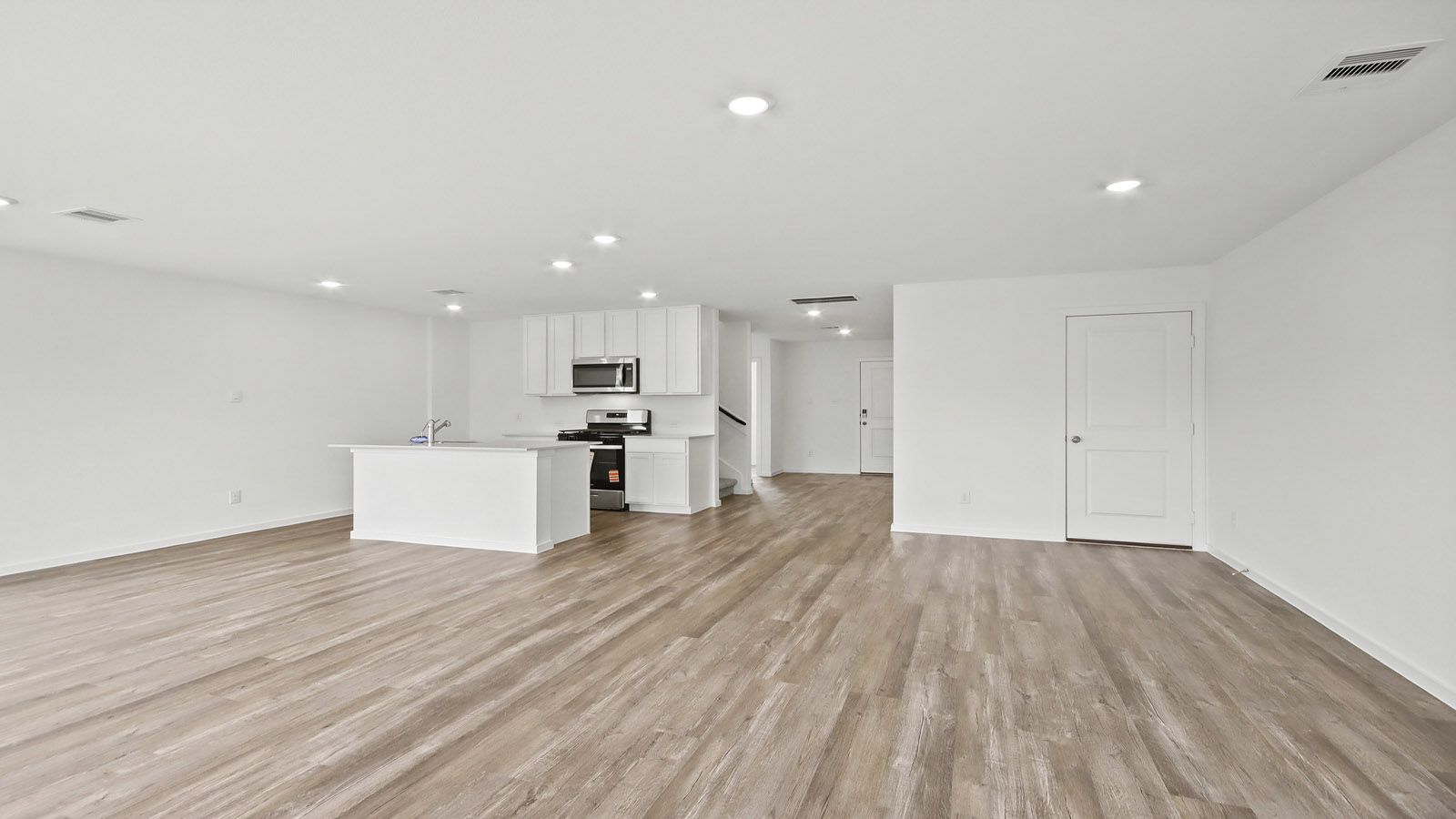 Spacious living area with vinyl flooring and bright windows in Magnolia TX