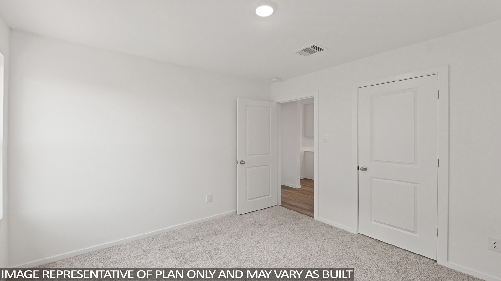 Secondary bedroom with windows, white walls, and light carpet.