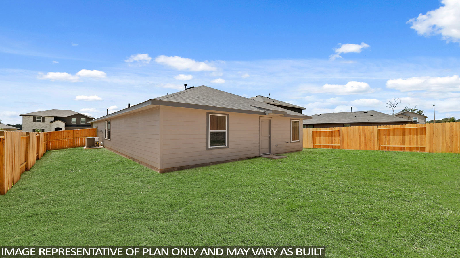 Landscaped backyard with a covered patio.