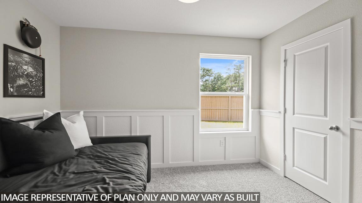 Secondary bedroom with carpet flooring and a bright window.