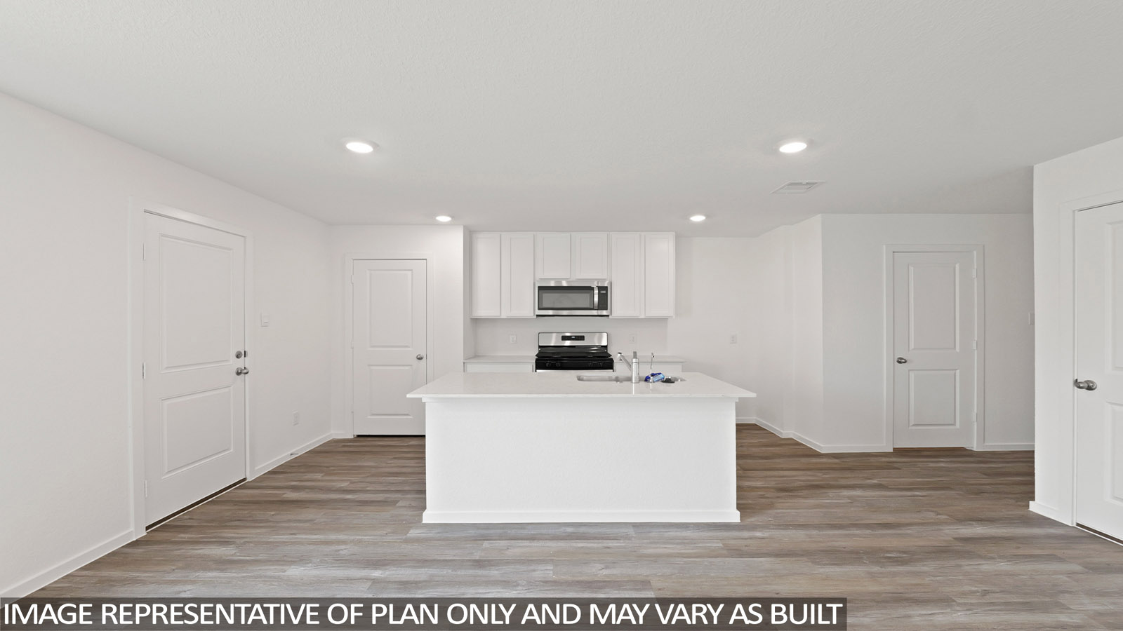 Open kitchen with an island, stainless steel appliances, white cabinets, white walls, and vinyl wood flooring.
