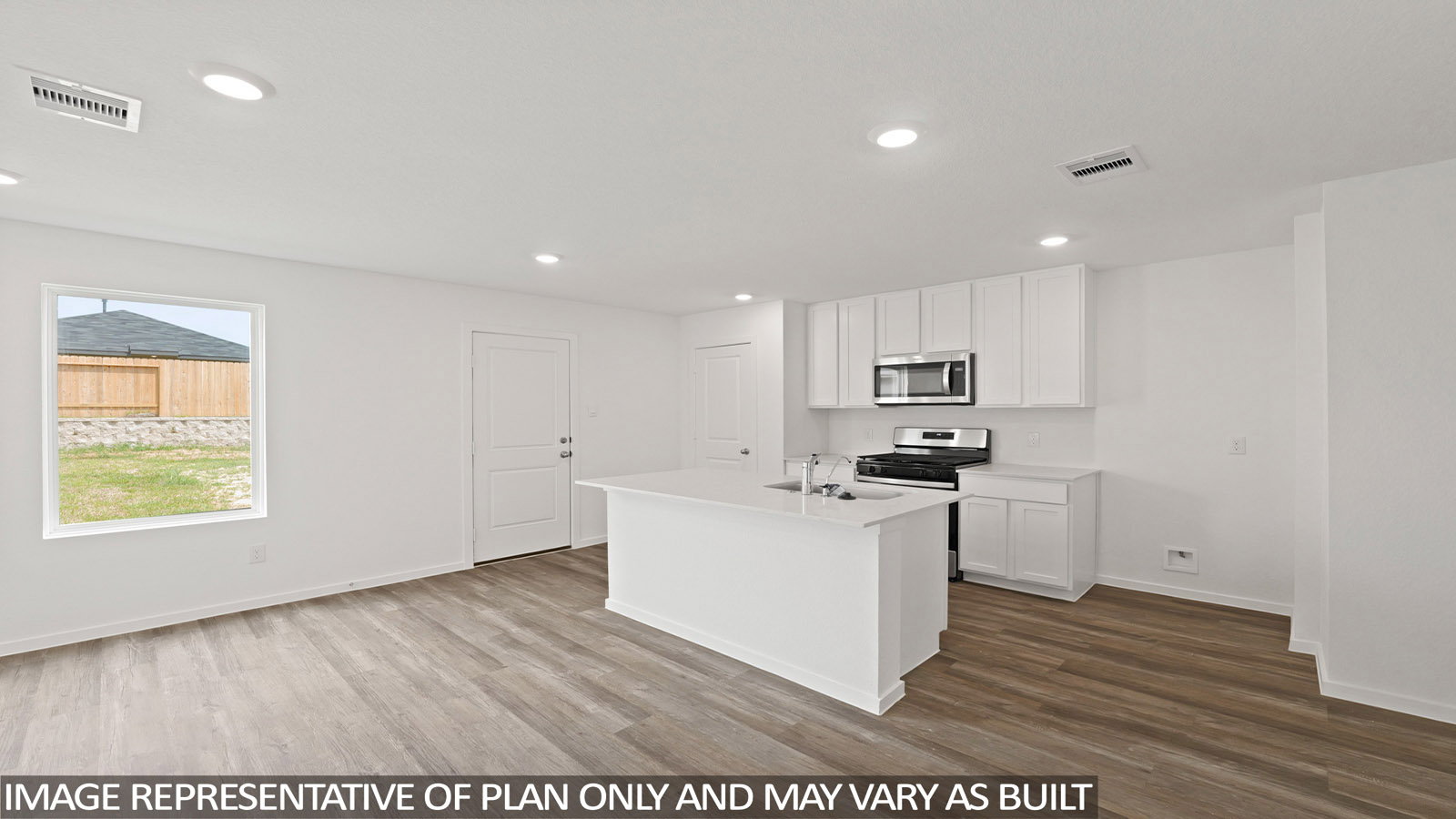 Open kitchen with an island, stainless steel appliances, white cabinets, white walls, and vinyl wood flooring.