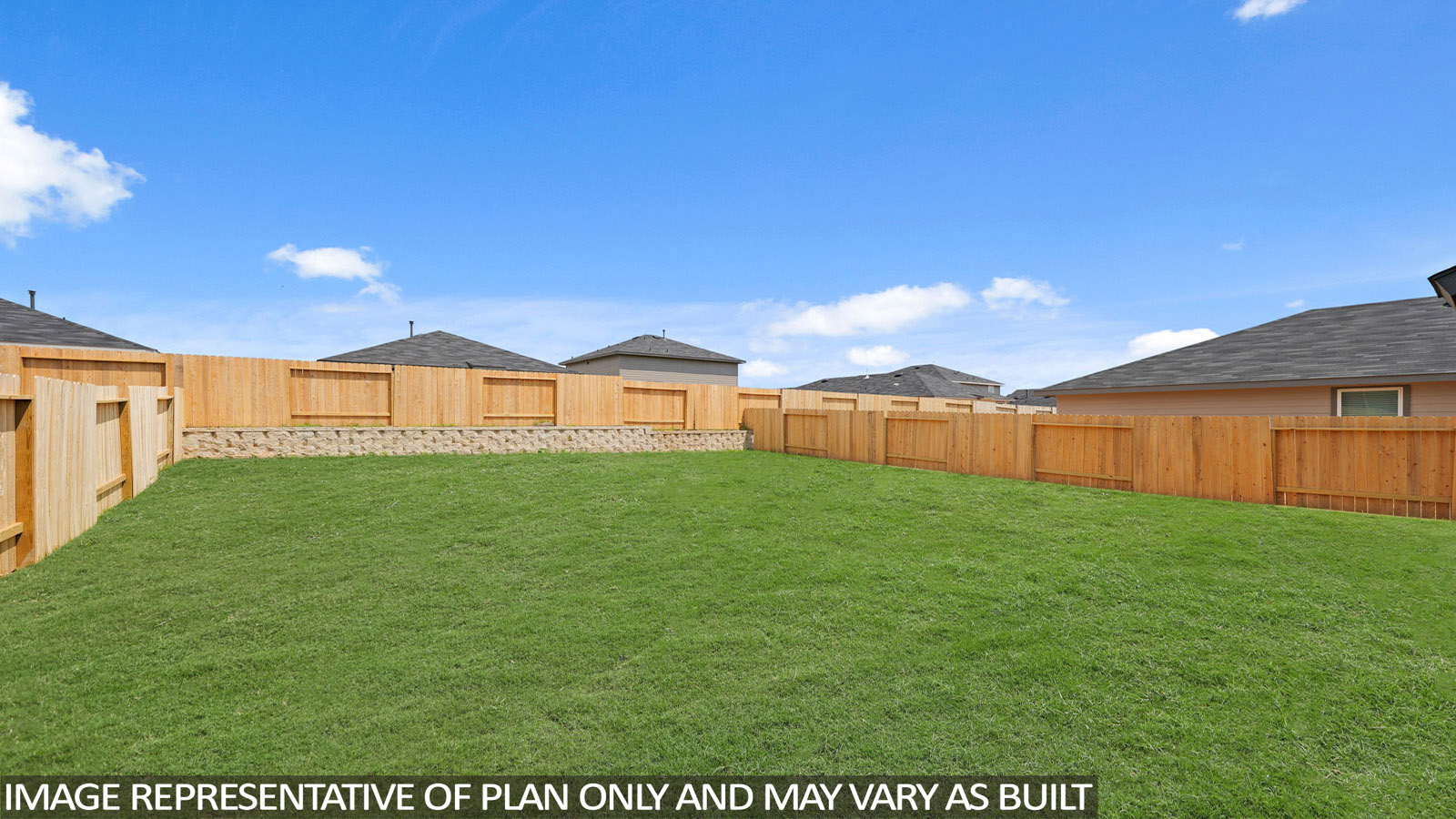 Landscaped backyard with a covered back door.