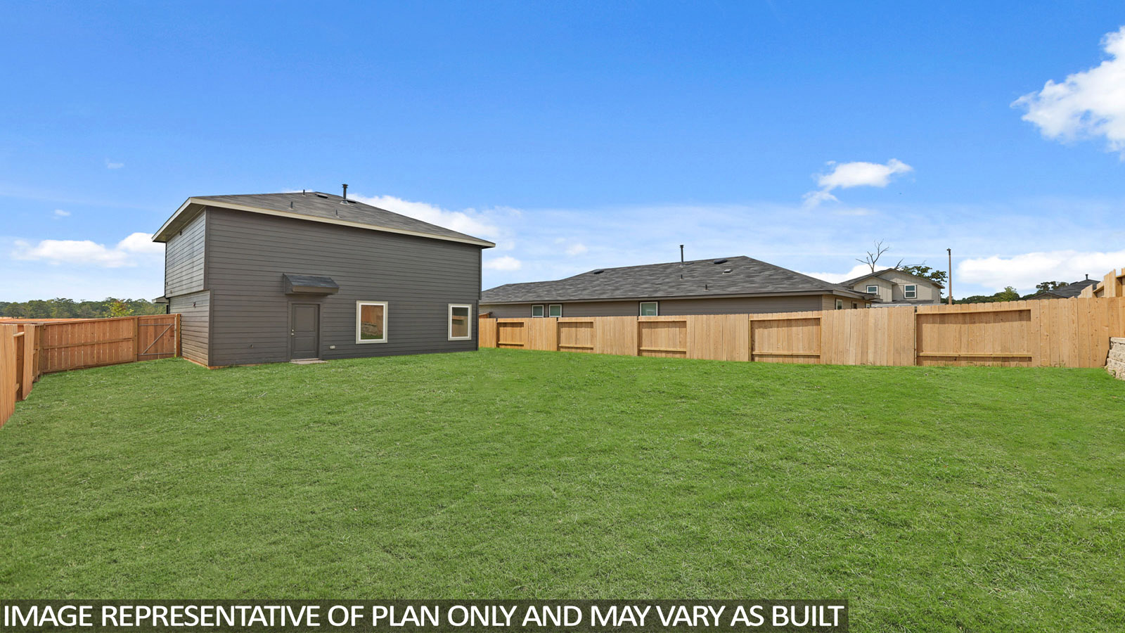 Landscaped backyard with a covered back door.