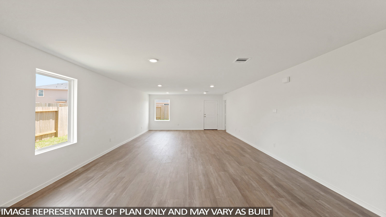 Open living room with windows, white walls, and vinyl wood flooring.