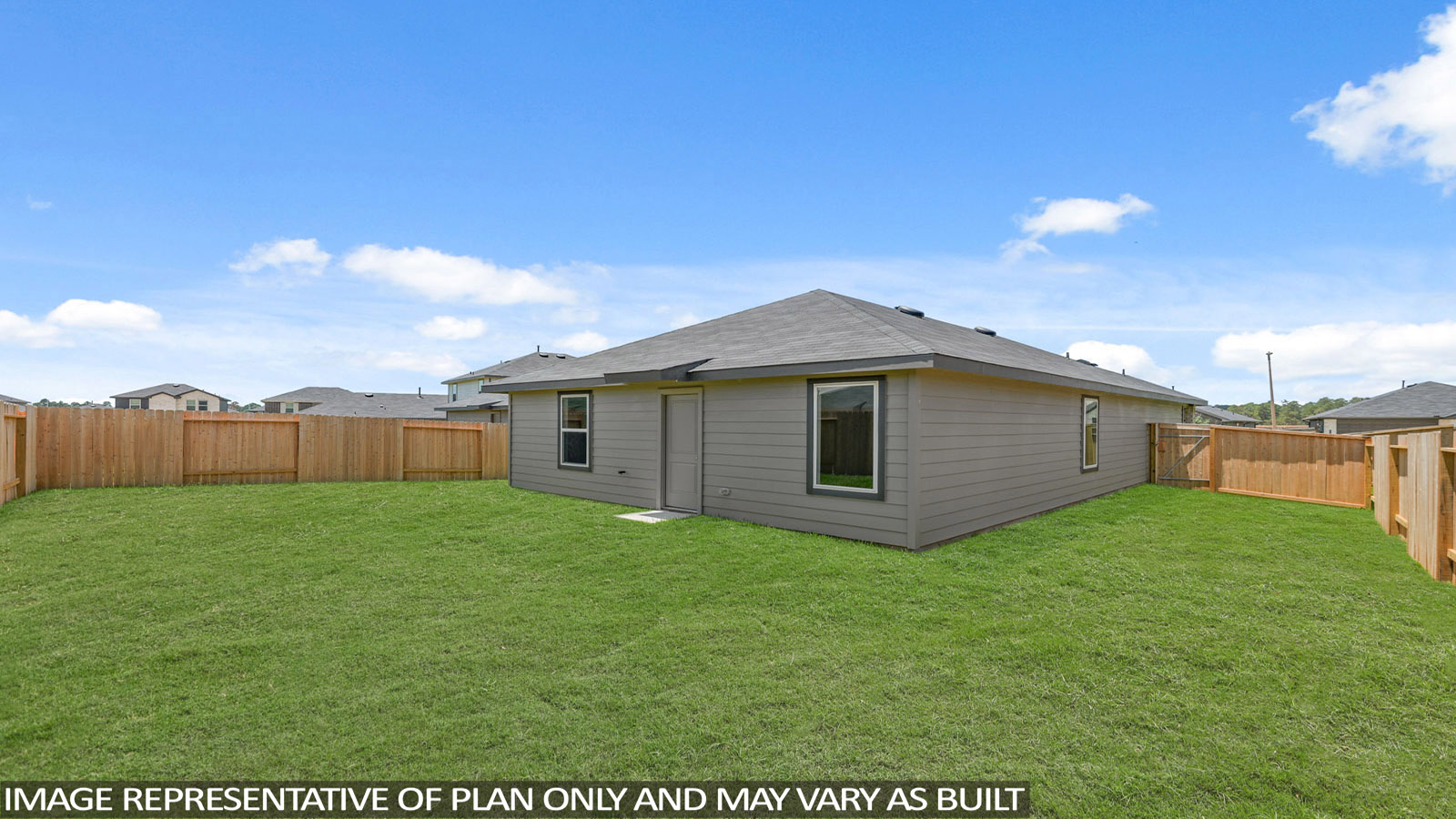 Landscaped backyard with a covered patio.