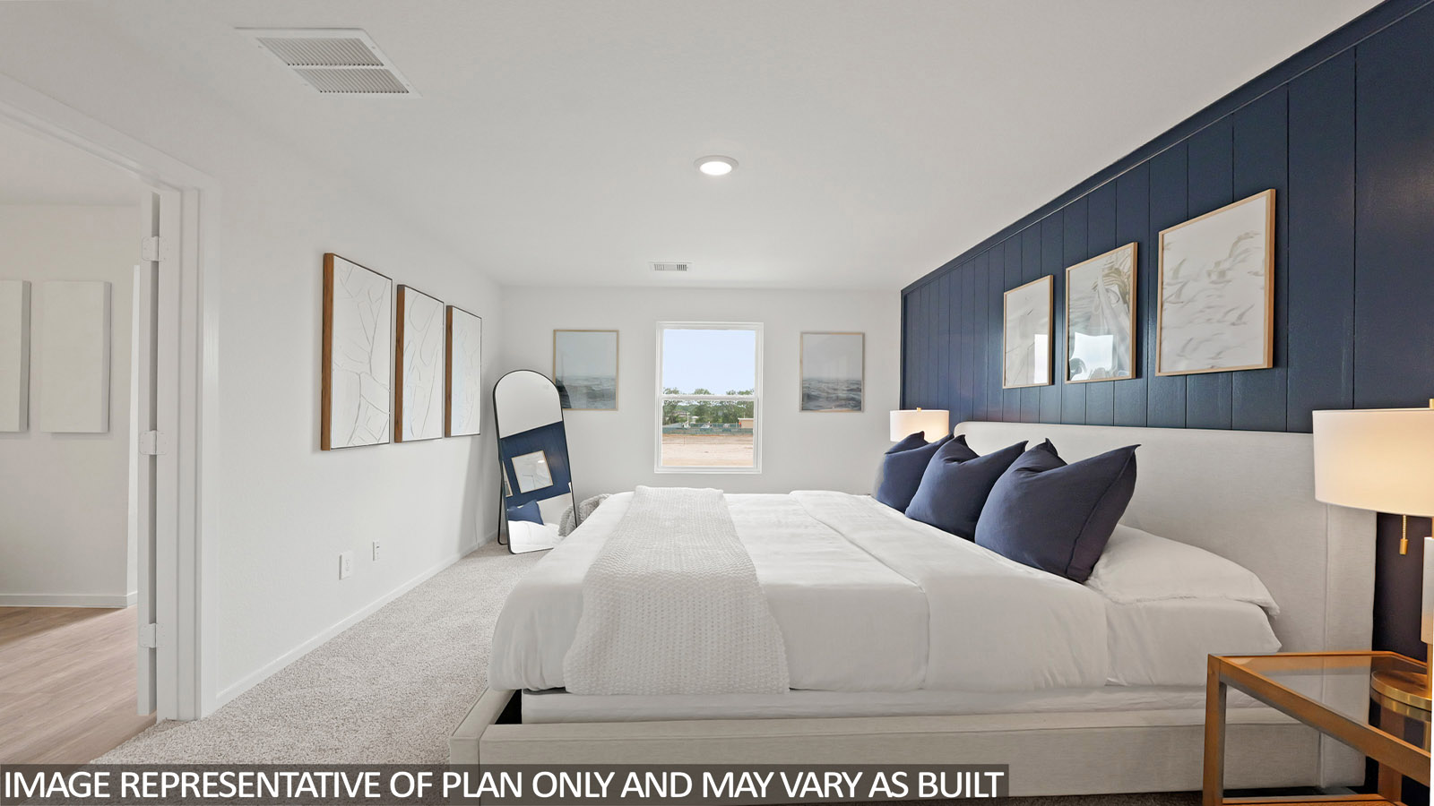 Primary bedroom with windows, white walls, and light carpet.