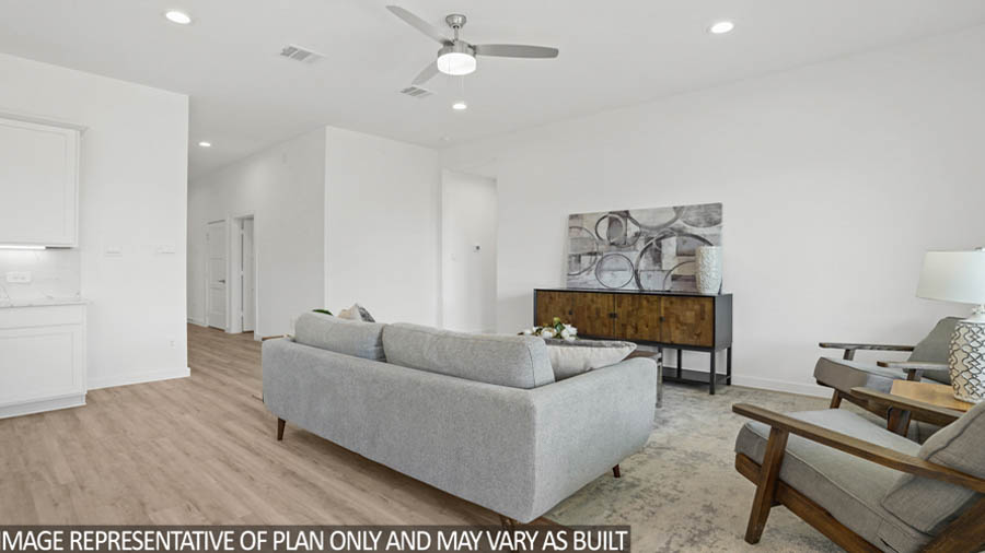 Spacious living area with vinyl flooring