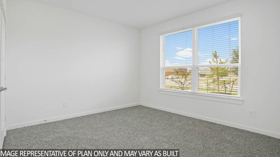 Secondary bedroom with carpet flooring