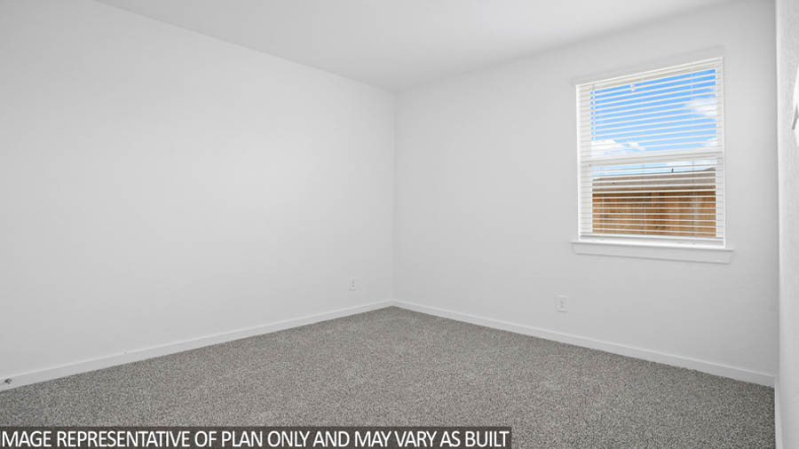 Secondary bedroom with carpet flooring